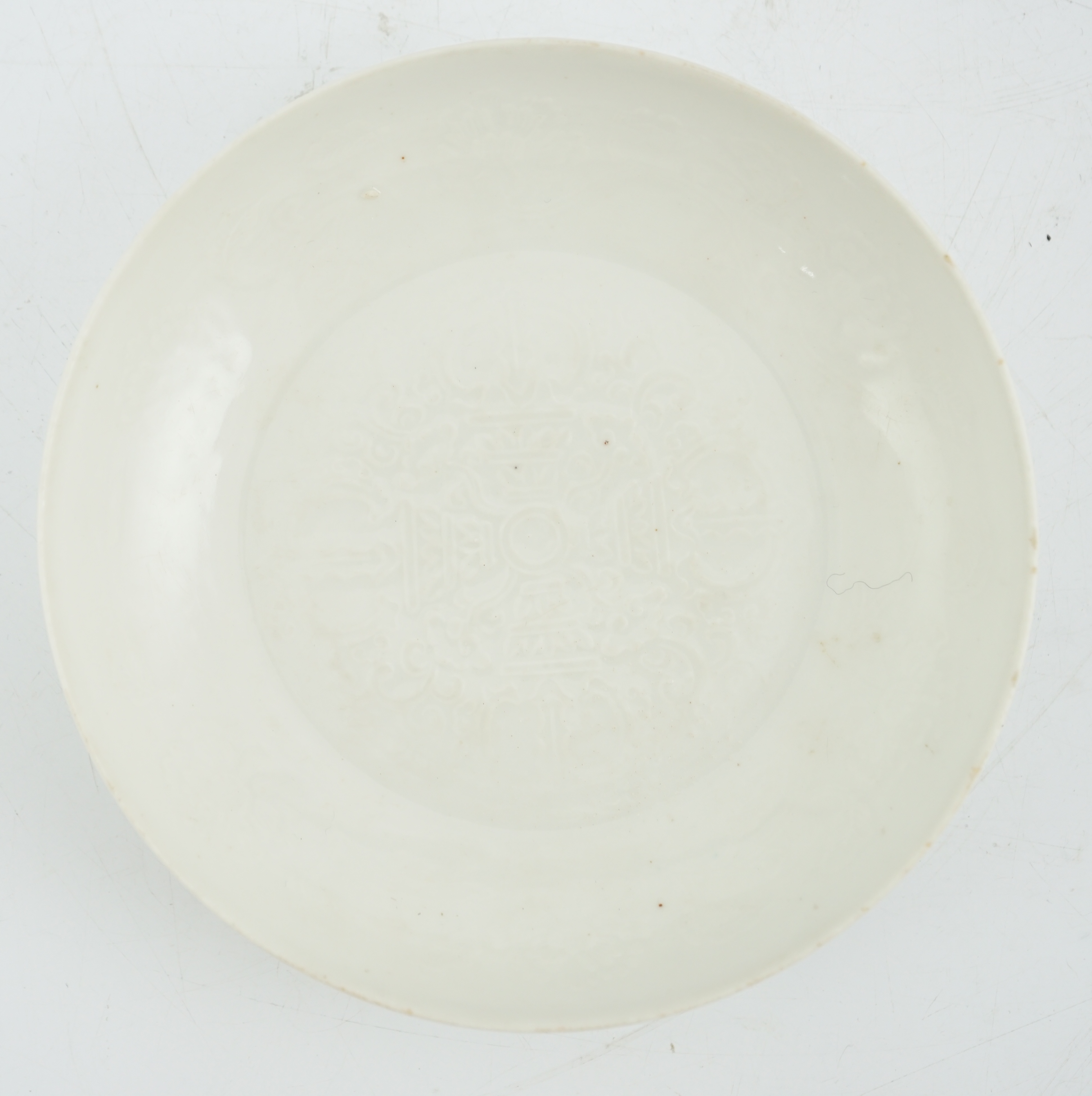 A Chinese moulded white glazed saucer dish, Yongle mark, Republic period